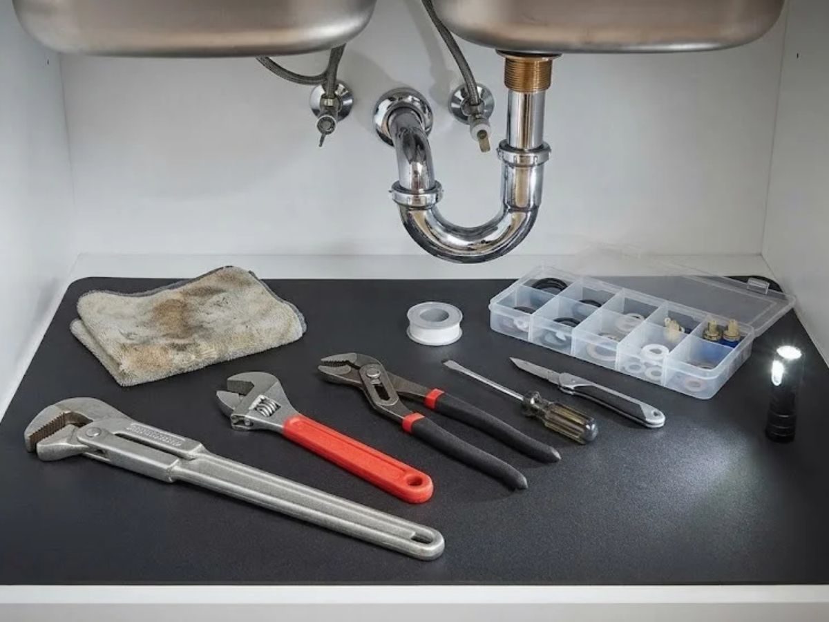 Kitchen faucet being repaired with tools