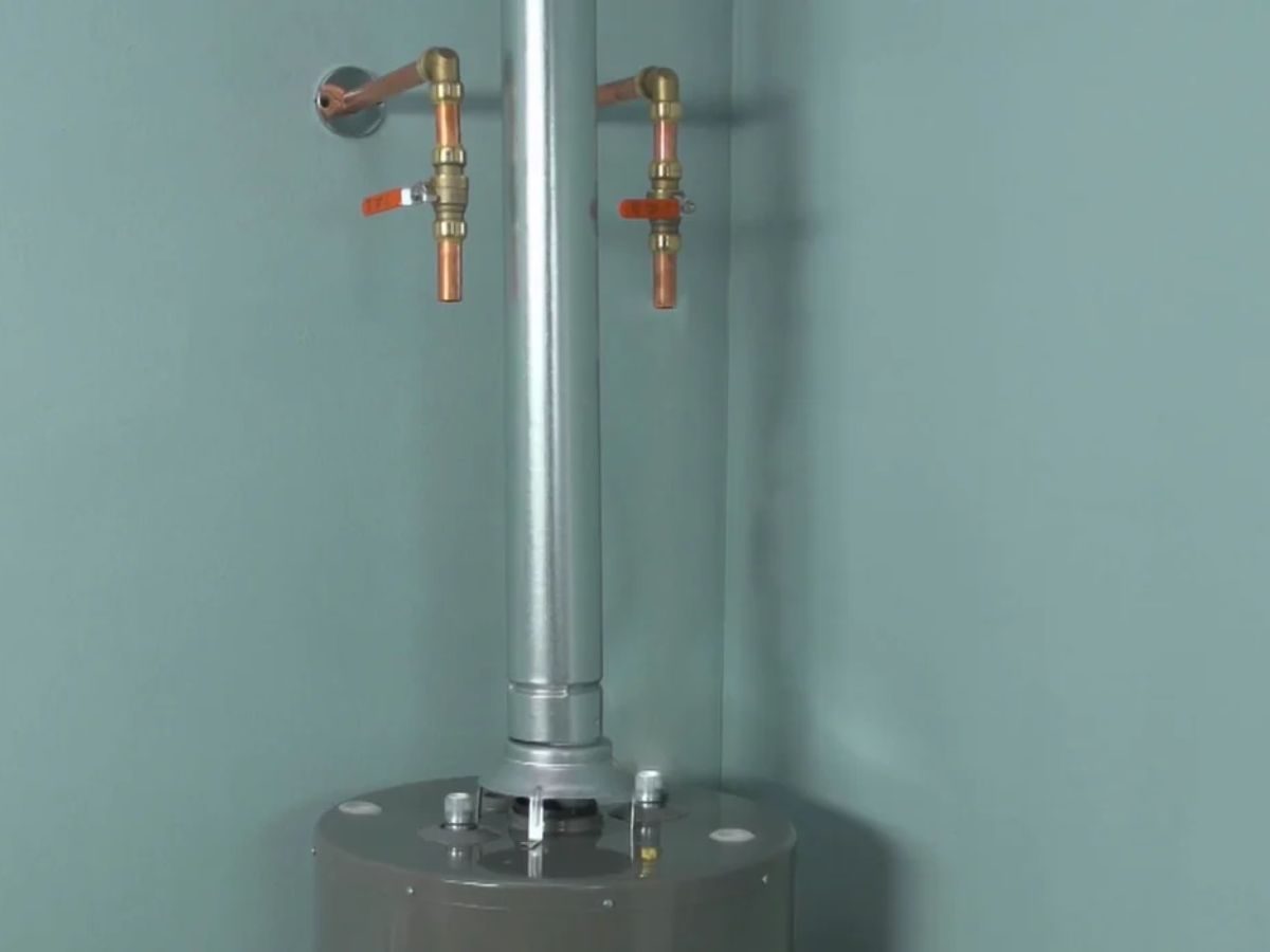 Technician repairing a water heater with tools